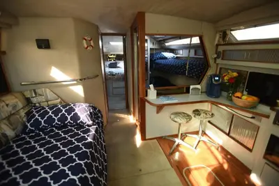 a small room with a bed and a mirror at Beautiful Yacht on Catskill Creek in Catskill
