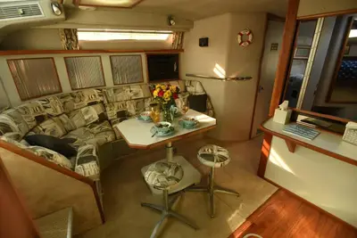 a small room with a couch and a table with flowers at Beautiful Yacht on Catskill Creek in Catskill