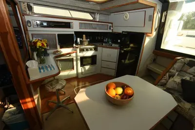 a kitchen with a bowl of fruit on a table at Beautiful Yacht on Catskill Creek in Catskill