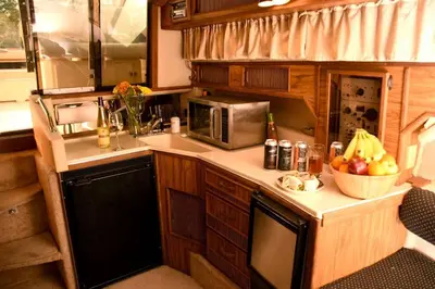 a kitchen with a counter with a bowl of fruit at Charming Yacht on Catskill Creek in Catskill