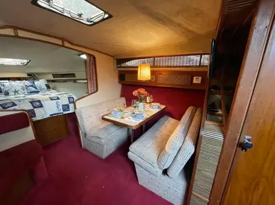 a small room with a table and a bed at Private Yacht on Catskill Creek in Catskill