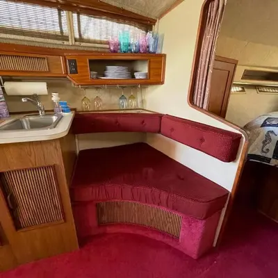 a small kitchen with a sink and a red bench at Private Yacht on Catskill Creek in Catskill