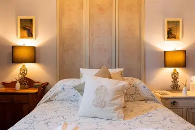 a bedroom with a bed with pillows and two lamps at Palazzo Hudson - Luxury Pool, Hot Tub, and Sauna in Hudson