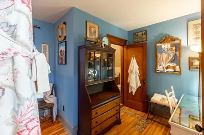 a blue room with a wooden dresser and a door at Palazzo Hudson - Luxury Pool, Hot Tub, and Sauna in Hudson