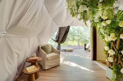 a living room with a couch and flowers at Unique Escapes - Nature Lovers Geodome in Monticello