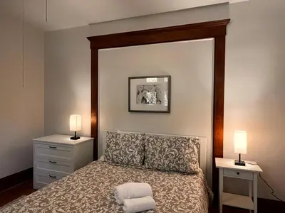 a bedroom with a bed with two night stands and two lamps at Comfortable and Tranquil -1st Fl in New Haven