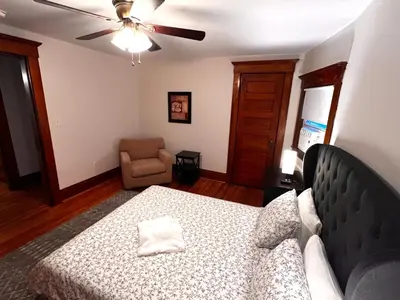 a bedroom with a bed and a couch and a chair at Comfortable and Tranquil -1st Fl in New Haven