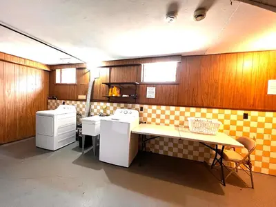 a kitchen with two white appliances and a table at Comfortable and Tranquil -1st Fl in New Haven