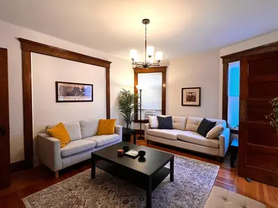 a living room with two couches and a table at Comfortable and Tranquil -1st Fl in New Haven