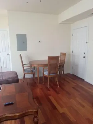 a dining room with a wooden table and chairs at 1 bedroom with free parking in Schenectady