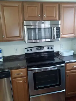 a kitchen with a stove and a microwave at 1 bedroom with free parking in Schenectady