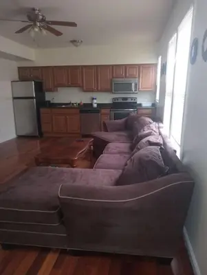 a living room with a couch and a kitchen at 1 bedroom with free parking in Schenectady