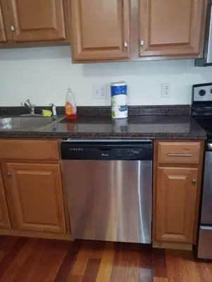 a kitchen with a stainless steel dishwasher next to a sink at 1 bedroom with free parking in Schenectady