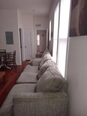 a living room with a large couch in a room at comfy cozy roomy in Schenectady