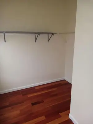 an empty room with white walls and wood floors at comfy cozy roomy in Schenectady