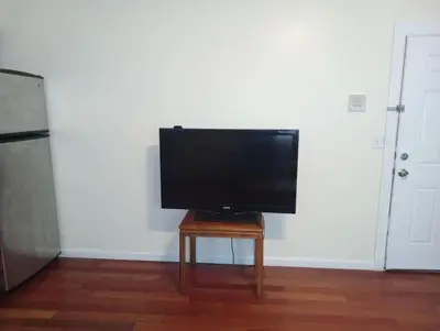 a flat screen tv sitting on top of a table at comfy cozy roomy in Schenectady