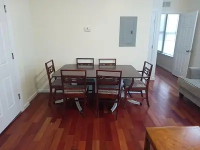 a dining room with a table and chairs and a couch at comfy cozy roomy in Schenectady