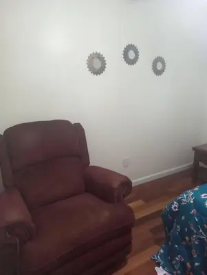 a living room with a couch and three gears on the wall at a nice one bedroom free parking in Schenectady