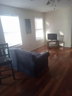 a living room with a couch and a tv at a nice one bedroom free parking in Schenectady