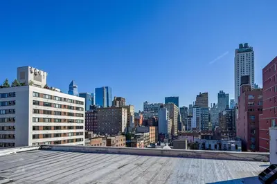 a view of a city skyline from the roof of a building at Modern one bedroom with private balcony in New York