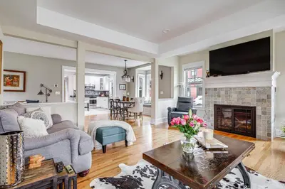 a living room with a couch and a fireplace at Elegant Saratoga Springs Stay Walk to Town, Track in Saratoga Springs