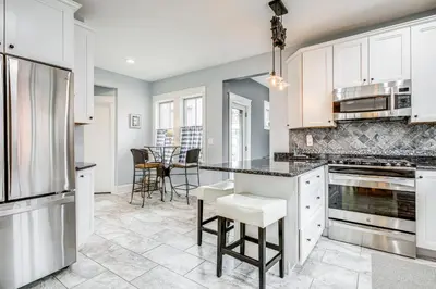a kitchen with white cabinets and a counter top at Elegant Saratoga Springs Stay Walk to Town, Track in Saratoga Springs