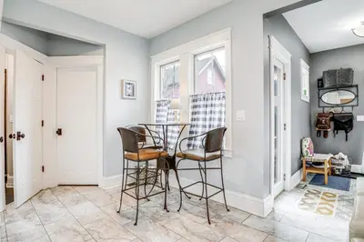 a dining room with a glass table and two chairs at Elegant Saratoga Springs Stay Walk to Town, Track in Saratoga Springs