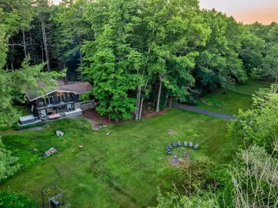 an aerial view of a house with a yard at Modern Lodge on 6 acres - 15 mins to Camelback in Cresco