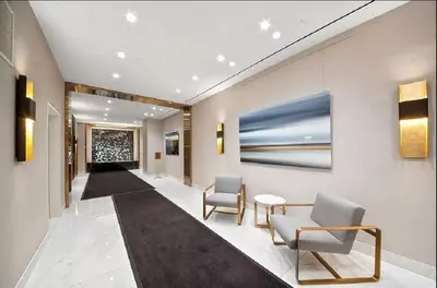 a lobby with chairs and a painting on the wall at PlanURstay - Spacious Midtown West Fully-Serviced - 1BR & 1BTH in New York