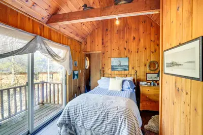 a bedroom with a bed and a balcony at Ski, Sip and Snuggle Cozy Catskills Gem with Views! in Athens