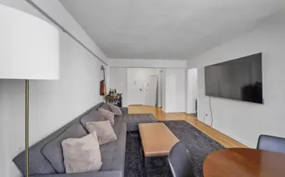 a living room with a couch and a table at Apartment near Times Square UWS Manhattan in New York