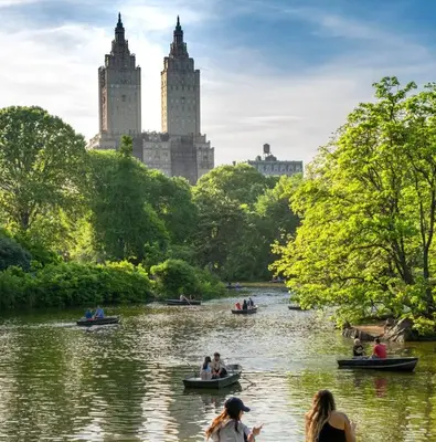 people in boats on a river in a park at Apartment near Times Square UWS Manhattan in New York