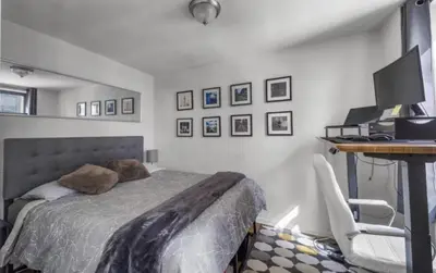 a bedroom with a bed and a desk with a computer at Apartment near Times Square UWS Manhattan in New York