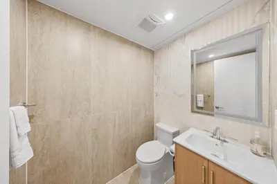 a bathroom with a toilet and a sink and a mirror at Private Room with Shared Bathroom at an Apartment by Times Square in New York