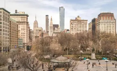 a city skyline with tall buildings and a park at Steps from Everything - Modern 1-Bdr in Downtown's Union Square in New York