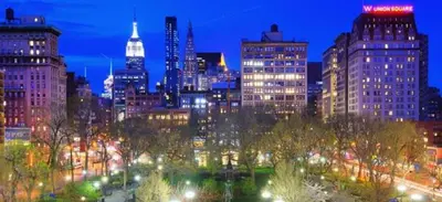 a view of a city at night with lights at Steps from Everything - Modern 1-Bdr in Downtown's Union Square in New York