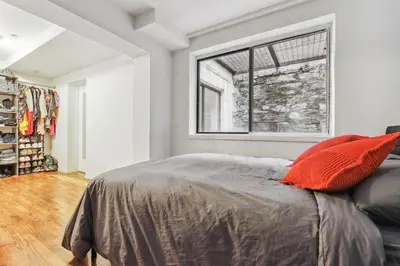 a bedroom with a bed and a window at American Dream Guest House in New York