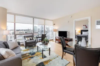 a living room with a couch and a table at Spacious Apartment Downtown in Stamford