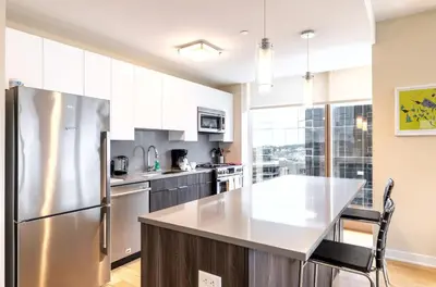 a kitchen with a stainless steel refrigerator at Spacious Apartment Downtown in Stamford