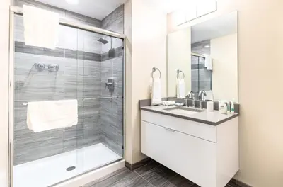 a bathroom with a shower and a sink at Spacious Apartment Downtown in Stamford