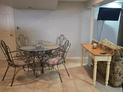 a dining room with a table and chairs and a couch at Shelton Affordable Gateway in Shelton