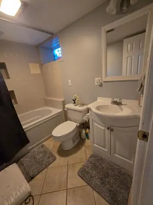 a bathroom with a toilet and a sink and a bath tub at Shelton Affordable Gateway in Shelton
