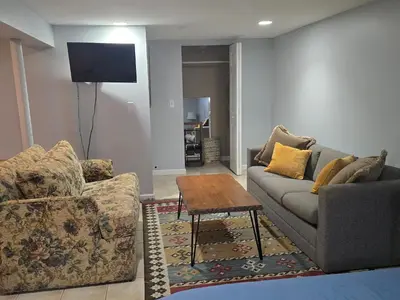 a living room with two couches and a table at Shelton Affordable Gateway in Shelton