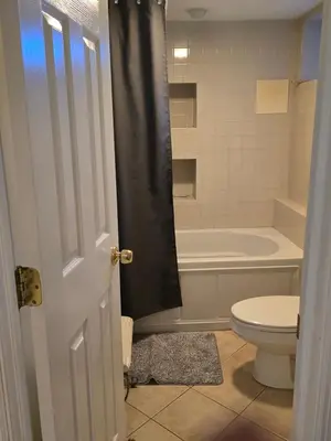 a bathroom with a toilet and a bath tub at Shelton Affordable Gateway in Shelton