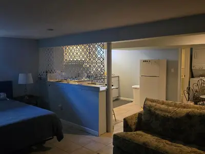 a room with a kitchen with a sink and a couch at Shelton Affordable Gateway in Shelton