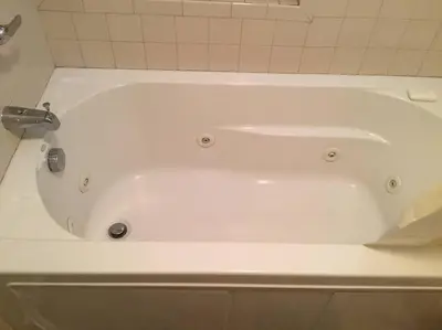 a white bath tub with a faucet in a bathroom at Shelton Affordable Gateway in Shelton