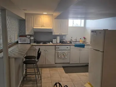 a kitchen with white cabinets and a white refrigerator at Shelton Affordable Gateway in Shelton