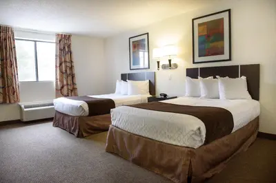 a hotel room with two beds and a window at Americas Best Value Inn New Paltz in New Paltz
