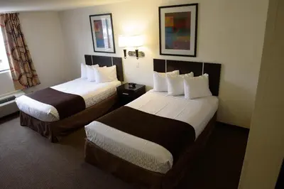 a hotel room with two beds and a window at Americas Best Value Inn New Paltz in New Paltz