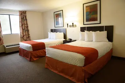 a hotel room with two beds and a window at Americas Best Value Inn New Paltz in New Paltz